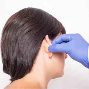 plastic surgeon doctor examines a patient after otoplasty 300x300 1