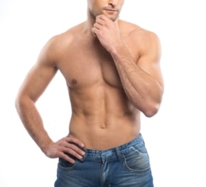 Handsome young man in blue jeans with naked torso 300x272 1