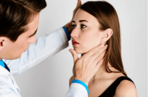 The doctor a man put his hand on the patients neck to assess the severity of the profile